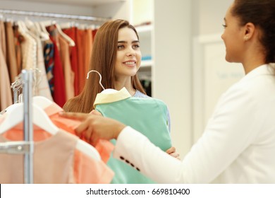 Beautiful Young Woman Smiling Getting Help From A Shop Assistant While Choosing Clothes At The Store Shopping Shopaholic Buying Buyer Customer Service Client People Communication Advice Sale Concept