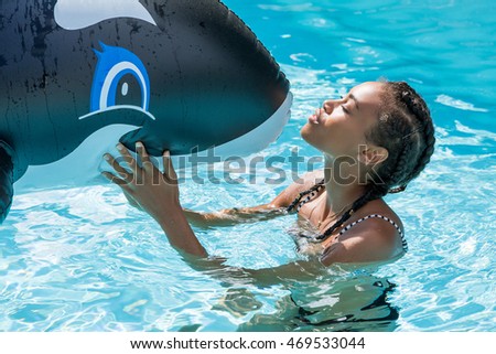 Beautiful young woman smiling in a swimming pool
