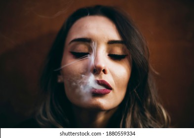 Beautiful Young Woman Smokes Cigarette Outside The City. The Girl Addicted To Smoking
