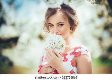 Beautiful Young Woman In Spring Garden