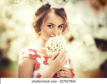 Beautiful Young Woman In Spring Garden