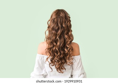 Beautiful young woman with stylish hairdo on color background, back view - Powered by Shutterstock