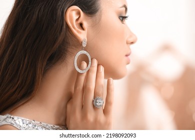 Beautiful young woman with stylish jewelry at home - Powered by Shutterstock