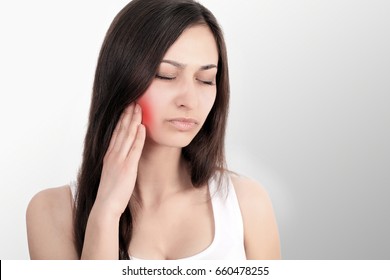Beautiful young woman suffering from toothache, close-up. Cuddles. Pain in the jaw Treatment of toothache. - Shutterstock ID 660478255