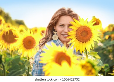 Beautiful Young Woman In Sunflower Field On Summer Day