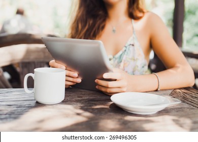 Beautiful Young Woman In Sunglasses Sitting In A Cafe Drinking Coffee/tea And Work On Your Tablet On The Internet, Apple Style, Ipad Pro