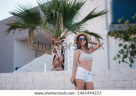 Similar – Brunette surfer woman with top and bikini holding surfboard