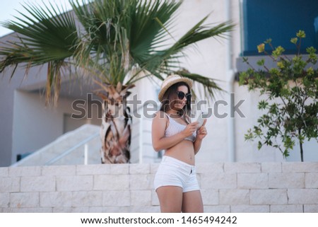 Similar – Brunette surfer woman with top and bikini holding surfboard