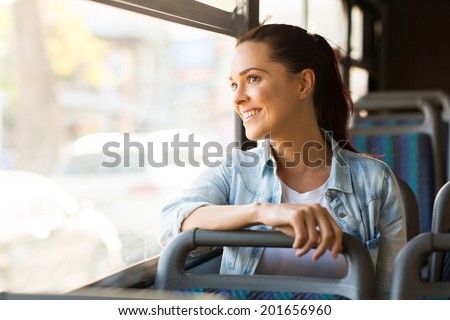 beautiful young woman taking bus to work