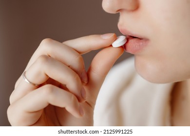 Beautiful Young Woman Taking Pills, Closeup. Sick Ill Woman Holding Antidepressant Painkiller Antibiotic Pill Glass Of Water Take Medicine, Female Handing Tablet Meds To Mouth To Relieve Pain, Health 