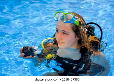 Beautiful Young Woman Taking A Scuba Diving Lesson In Swimming Pool