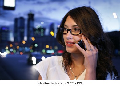 Beautiful Young Woman Talking On Mobile Phone In Night City. Shallow DOF.