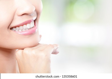 Beautiful young woman teeth close up with copy space on the right side. Isolated over green background, asian beauty model - Powered by Shutterstock