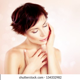 Beautiful Young Woman touching her Face. Skincare. Perfect Skin