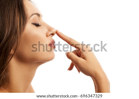 Beautiful young woman touching her nose