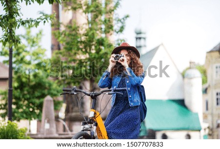 Similar – Image, Stock Photo Girl using electric scooter in the street in downtown rented by using service on smartphone. Candid people, real moments, authentic situations