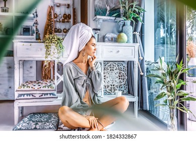 beautiful young woman with towel on head drink coffee in the morning