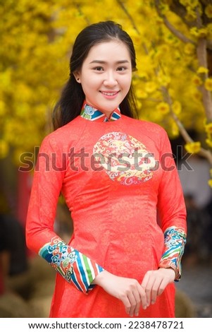 A beautiful young woman in traditional Vietnamese dress.