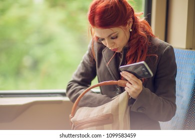 Beautiful Young Woman In The Tram, Subway, Train With Cell Phone, Looking In Her Hand Bag, Purse, Autumn Mood Colors