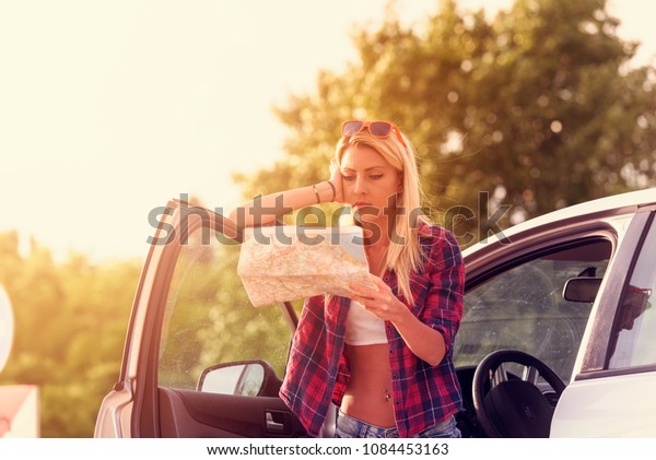 Beautiful young\
woman traveler lost on\
highway
