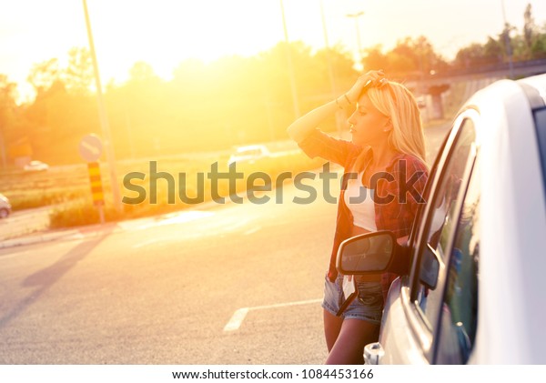 Beautiful young\
woman traveler lost on\
highway