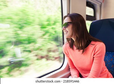 Beautiful young woman traveling by train