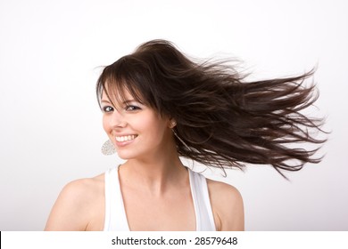 A beautiful young woman twirls with her long hair flowing. - Powered by Shutterstock