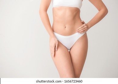 Beautiful Young Woman In Underwear On Light Background. Concept Of Plastic Surgery