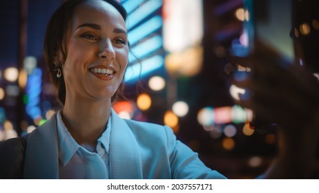 Beautiful Young Woman Using Smartphone for Video Call on Night City Street with Neon Lights. Portrait Smiling Female Using Mobile Phone Chatting with Family, Friends or Business Partners - Shutterstock ID 2037557171