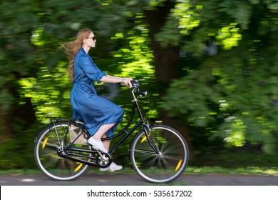 Beautiful Young Woman And Vintage Bicycle, Summer. Red Hair Girl Riding The Old Black Retro Bike Outside In The Park. Having Fun In The City