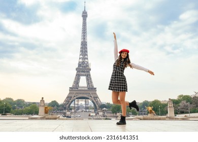 Beautiful young woman visiting paris and the eiffel tower. Parisian girl with red hat and fashionable clothes having fun in the city center and landmarks area - Powered by Shutterstock