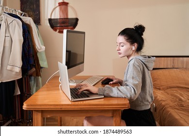 Beautiful Young Woman With Vitiligo Skin Working On Notebook While Sitting At The Table With Her Stationary Computer. Adorable Girl Looking At The Screen While Working At Home