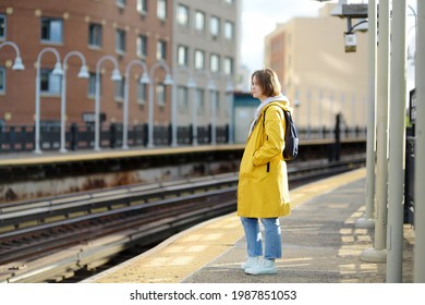 Beautiful Young Woman Is Waiting For A Train On A Platform In The New York Subway. Transport Of NYC, USA. Tourism And Travel In NY.