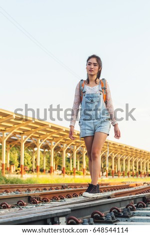 Beautiful young woman waiting for the train