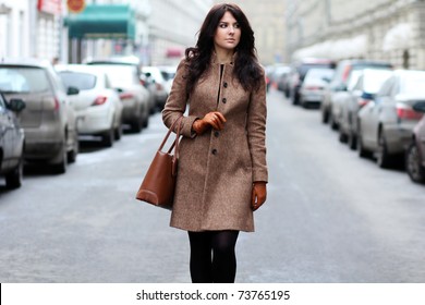 Beautiful Young Woman Walking On The Street