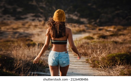 Beautiful Young Woman Walking Over A Wood Path