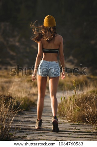 Similar – Image, Stock Photo Brunette girl holding surfboard over head and walking