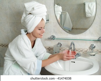  Beautiful young woman washing her face with water