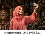 Beautiful young woman wearing colored abaya indoor in an arabian traditional cafe