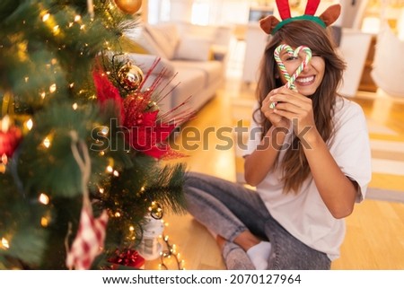 Similar – Image, Stock Photo Woman peeking through Christmas wrapping paper, festive mood