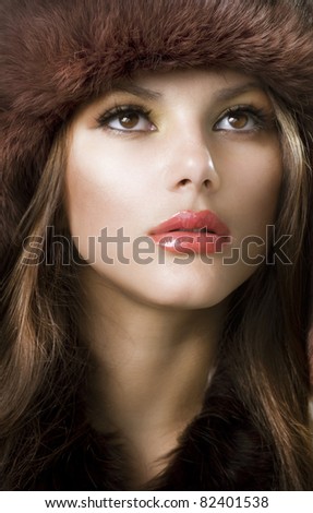 Beautiful Young Woman wearing Fur Hat.Winter Style