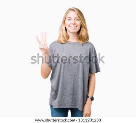 Beautiful young woman wearing oversize casual t-shirt over isolated background showing and pointing up with fingers number three while smiling confident and happy.