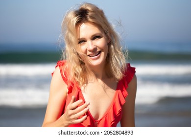 Beautiful Young Woman Wearing Red Swimsuit On The Beach Near Pacific Ocean