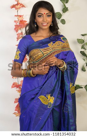 beautiful young woman wearing saree, indoor lighting, ethnic look