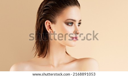 Beautiful young Woman  with wet hair effect  and clean fresh skin  .Girl  beauty face care. Facial  treatment   .