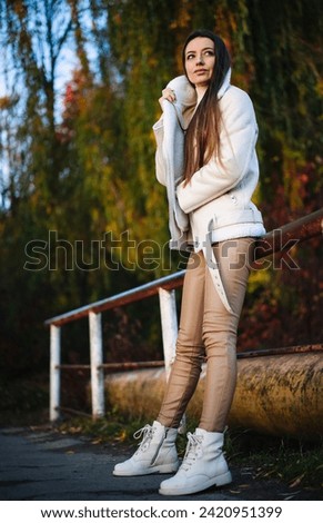 Similar – beautiful young woman smiling while walking in the park