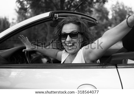 Similar – Happy young woman looking back through the window car