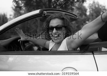 Similar – Happy young woman looking back through the window car