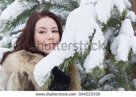 Beautiful young woman in the winter forest 
