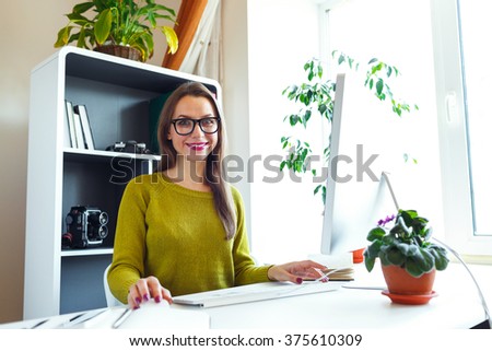 Beautiful young woman working from home - modern business concept